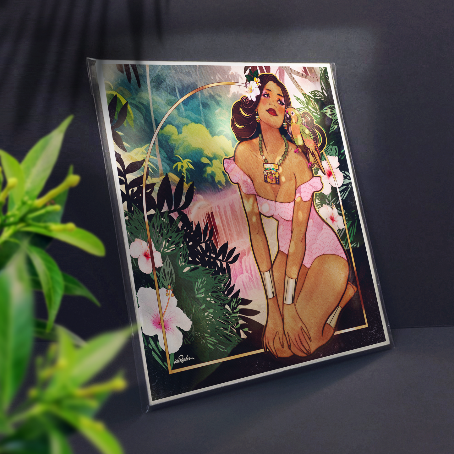 3/4 view of square print featuring a tropical tiki pin up girl with a pink dress and brown hair with a parrot on her shoulder. She is perched atop a cliff with a lush jungle backdrop and pink waterfall. 