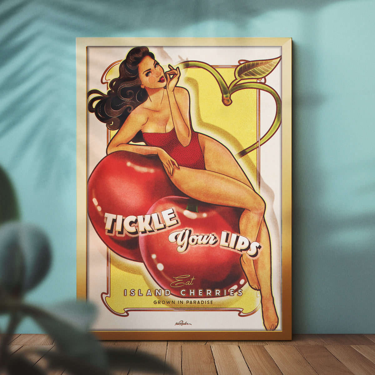 a framed poster featuring a vintage pin up art of a dark haired woman in a red bathing suit eating a cherry seductively. She is perched on giant cherries. The text reads "Tickle your Lips with Island Cherries"