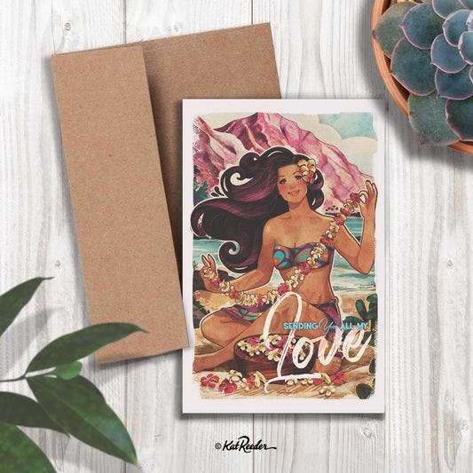 5x7 greeting card featuring an illustration of an island girl making a lei on a pink beach in the style of vintage travel posters. The message on the front of the card reads "Sending you all my love". A kraft paper envelope is included with the card. 